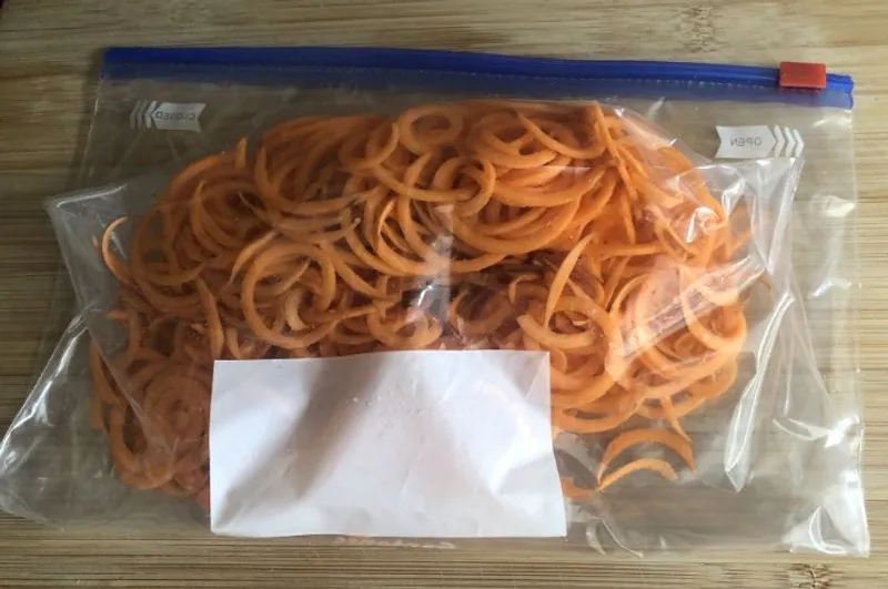 spiralized sweet potato in a ziploc bag ready for freezing