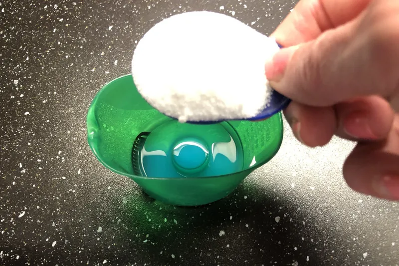 adding washing soda crystals to the laundry detergent