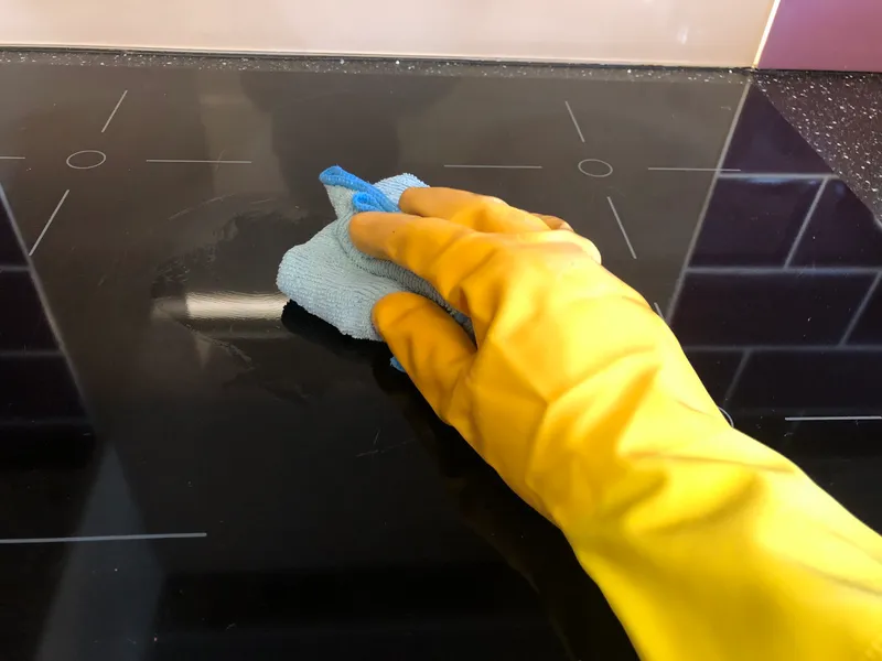 cleaning the induction hob with a microfiber cloth