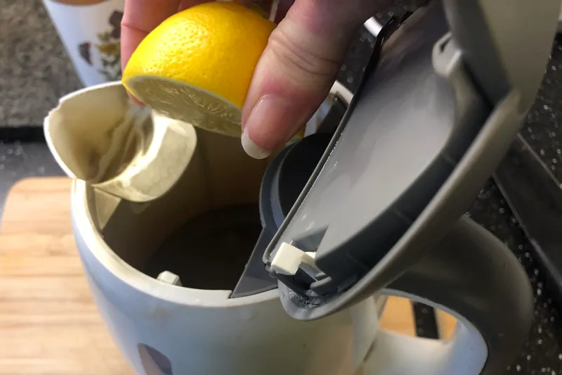 cleaning the inside of a kettle with lemon juice