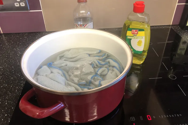 dishcloths boiling in vinegar and dish soap