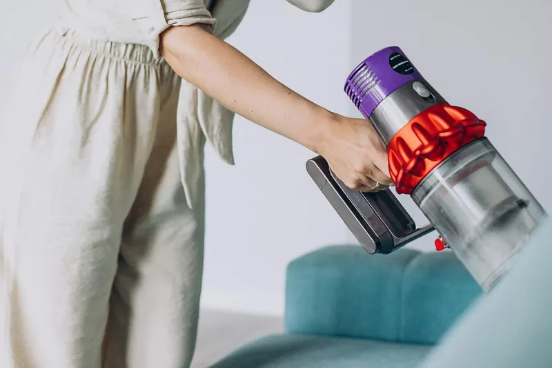 woman cleaning with a cordless Dyson vacuum