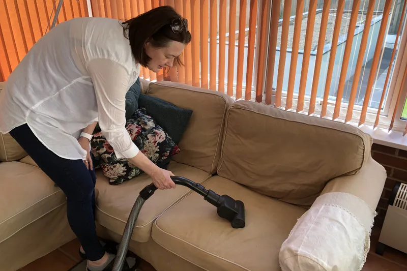 Me vacuuming the sofa with the Miele turbo mini