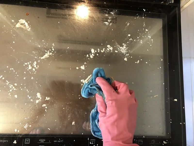 scrub oven door with baking soda