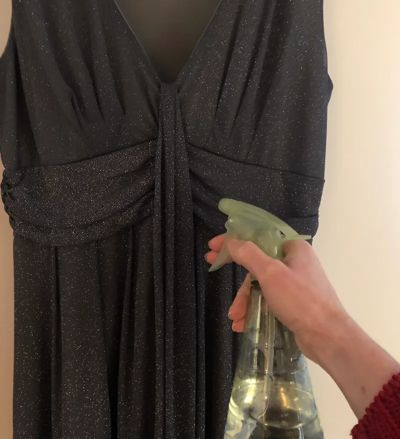 spraying clothes with vinegar