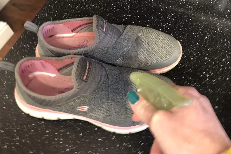 Spraying the shoe to be cleaned with water