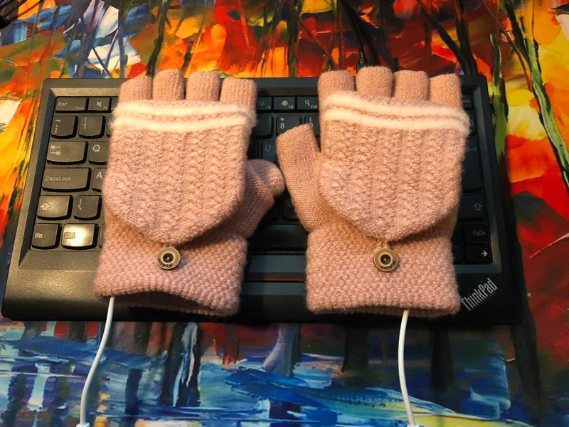 usb heated glove on top of keyboard