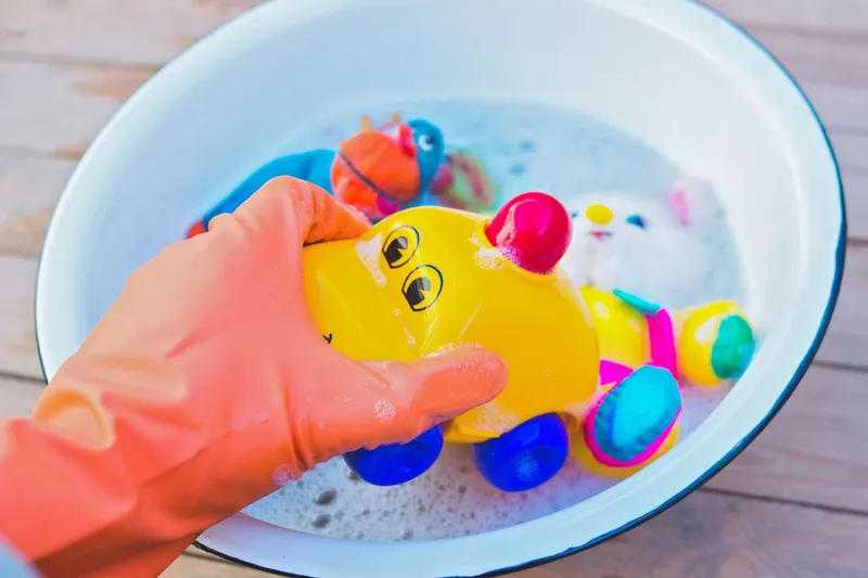 washing toys in soap and water