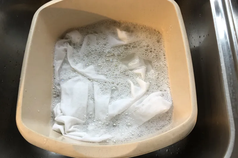 white clothing with tea stain soaking in bleach