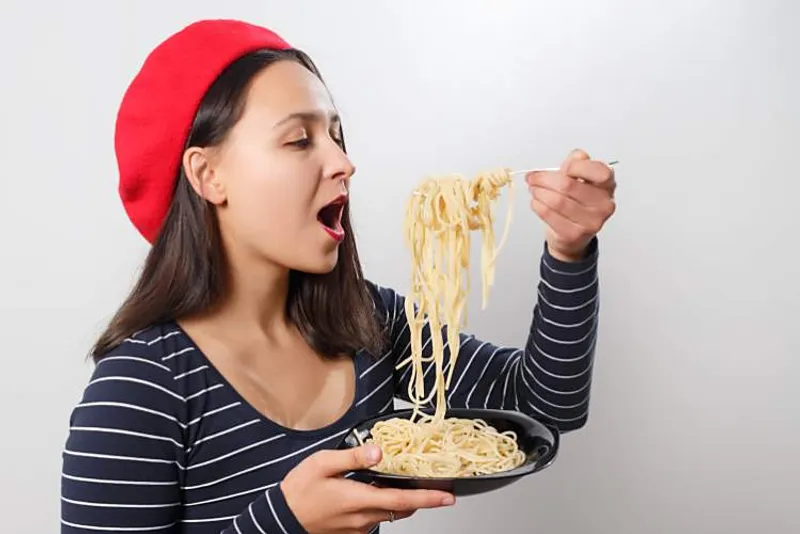 woman enjoying pasta