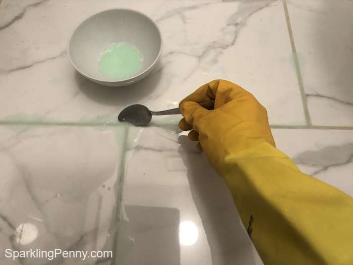 applying the homemade cleaner to the grout