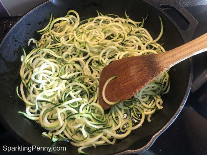 Courgettes cooking in a cast-iron skillet