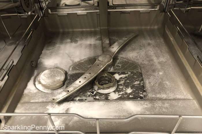 baking soda sprinkled on the bottom of a dishwasher