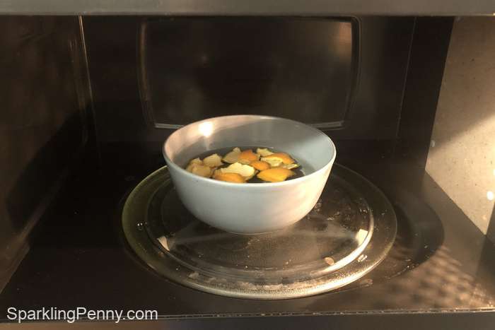 bowl of orange peels and water in a microwave