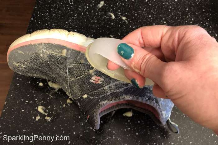Cleaning the outside of a colored shoe with baking soda and dish soap