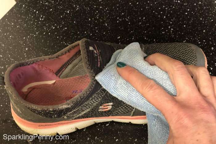 Dabbing the outside of the shoe with a microfibre cloth to remove the soap