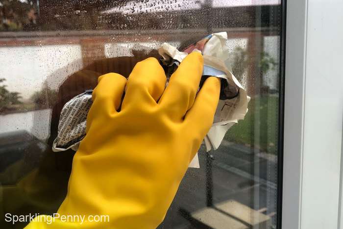 cleaning a window with newspaper