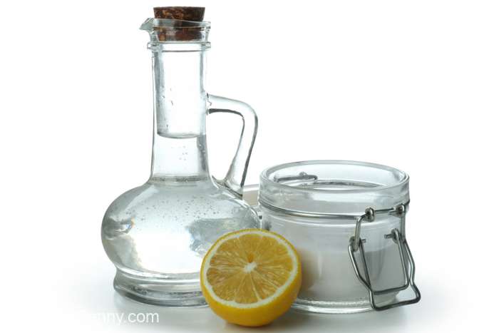 bottle of vinegar and a lemon