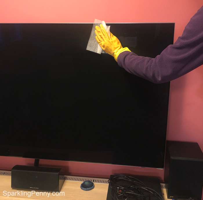 wiping a flat screen TV with a dryer sheet